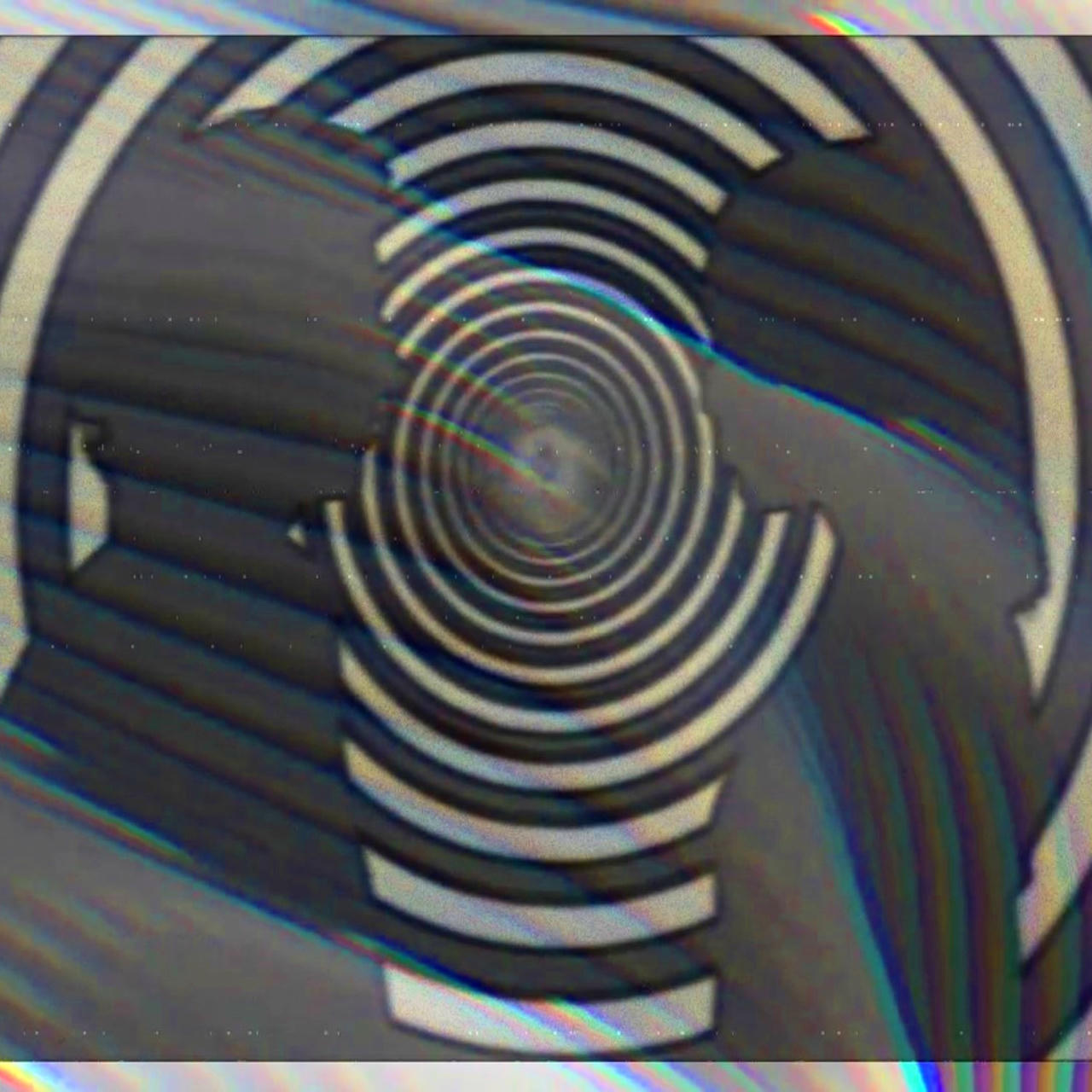 Two figures face each other, Electric Company style, with a black and white swirling bullseye.