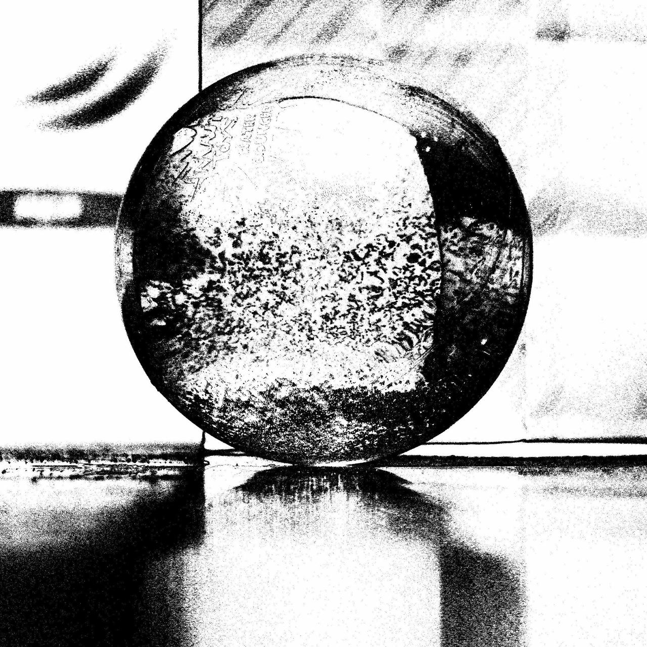 A palantir-like crystal ball in gritty black and white.